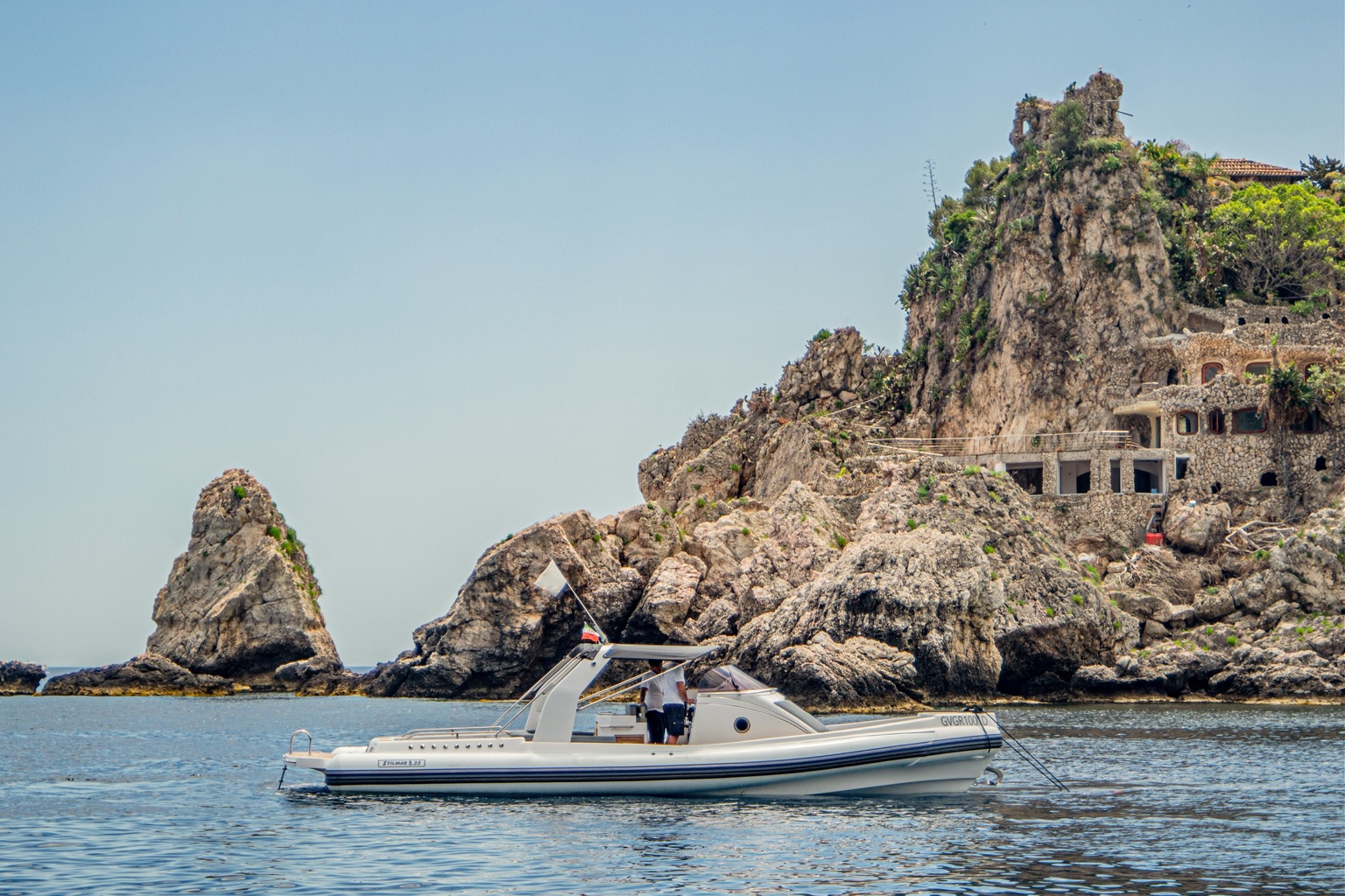 Stilmar 35 Cabin moored beside the dramatic rocky coast of Isola Bella