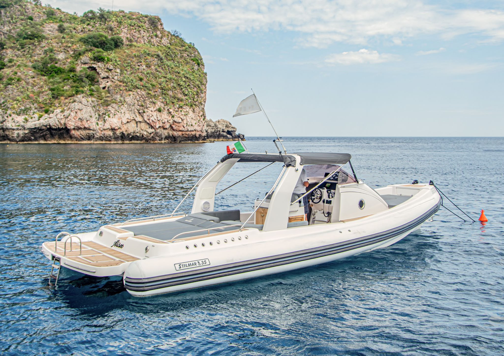 A closer view of the Stilmar 35 Cabin showing its sunbathing cushions, canopy and swimming platform